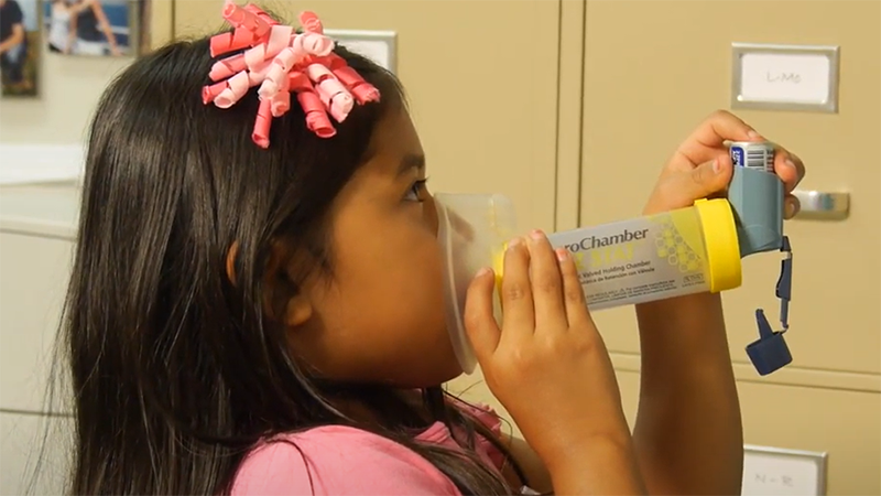 girl using inhaler