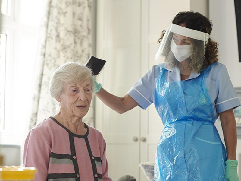 caregiver combing a patient's hair
