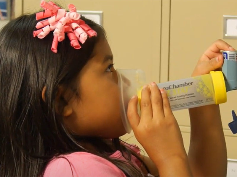 girl using inhaler